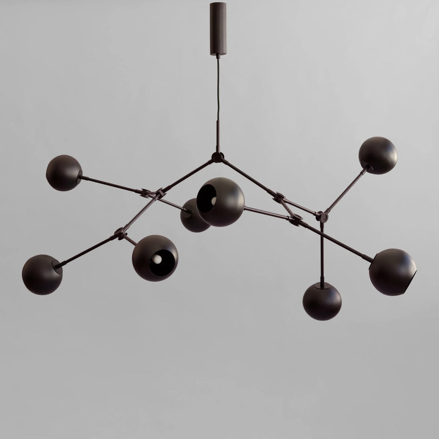 Modern black chandelier against a gray background from 101 Copenhagen available at Spacio retail stores in Mumbai & Kolkata. 