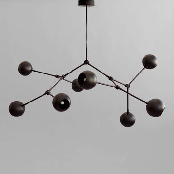Modern black chandelier with multiple spherical lights on a gray background from 101 Copenhagen available at Spacio retail stores in Mumbai & Kolkata. 