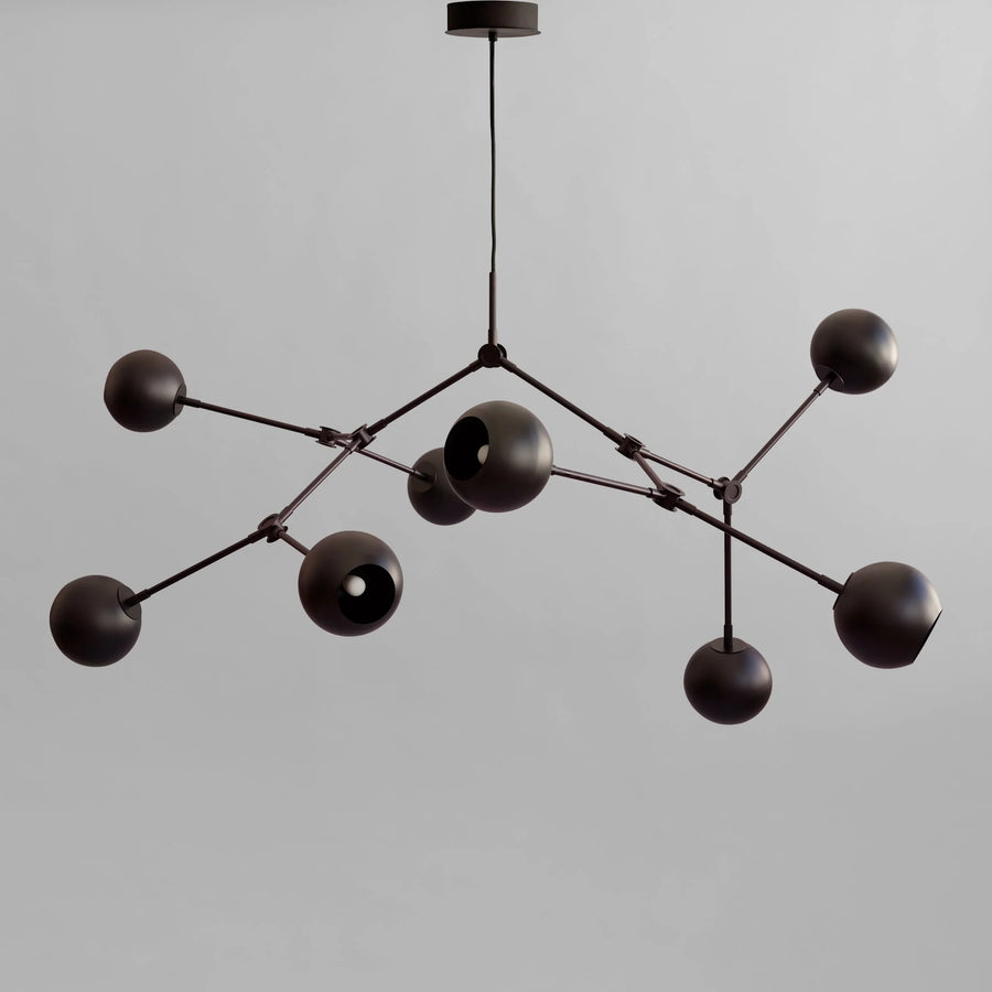 Modern black chandelier with multiple spherical lights on a gray background from 101 Copenhagen available at Spacio retail stores in Mumbai & Kolkata. 