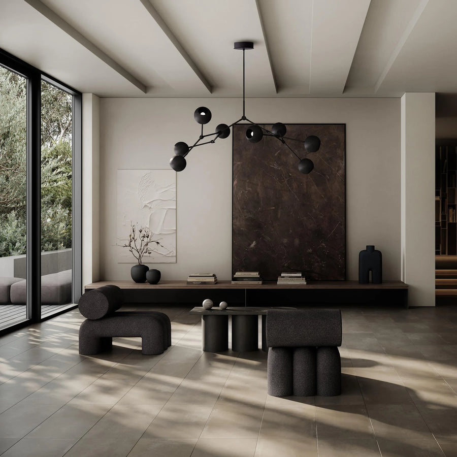 Modern living room with black furniture and chandelier