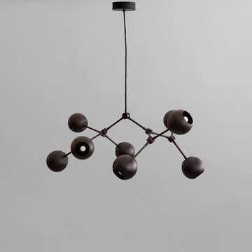 Modern black chandelier against a gray background from 101 Copenhagen available at Spacio retail stores in Mumbai & Kolkata. 