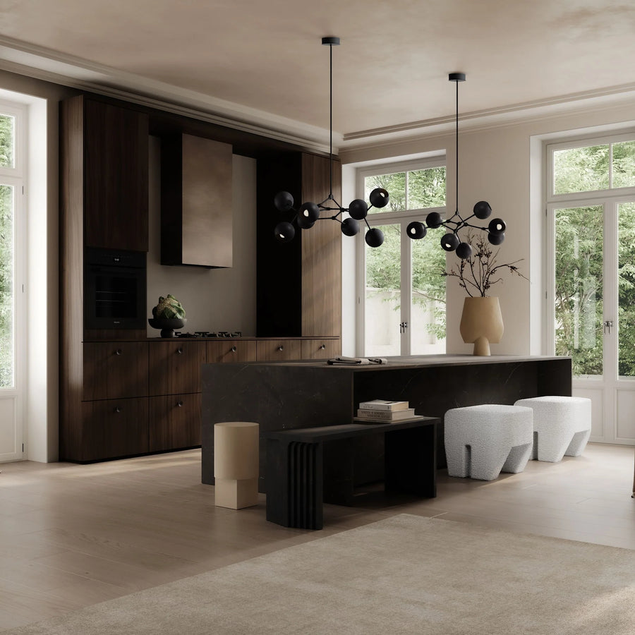 Modern living room with dark wood furniture, white ottomans, and large windows.