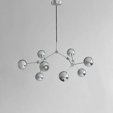 Modern chandelier with multiple spherical lights on a gray background from 101 Copenhagen available at Spacio retail stores in Mumbai & Kolkata. 