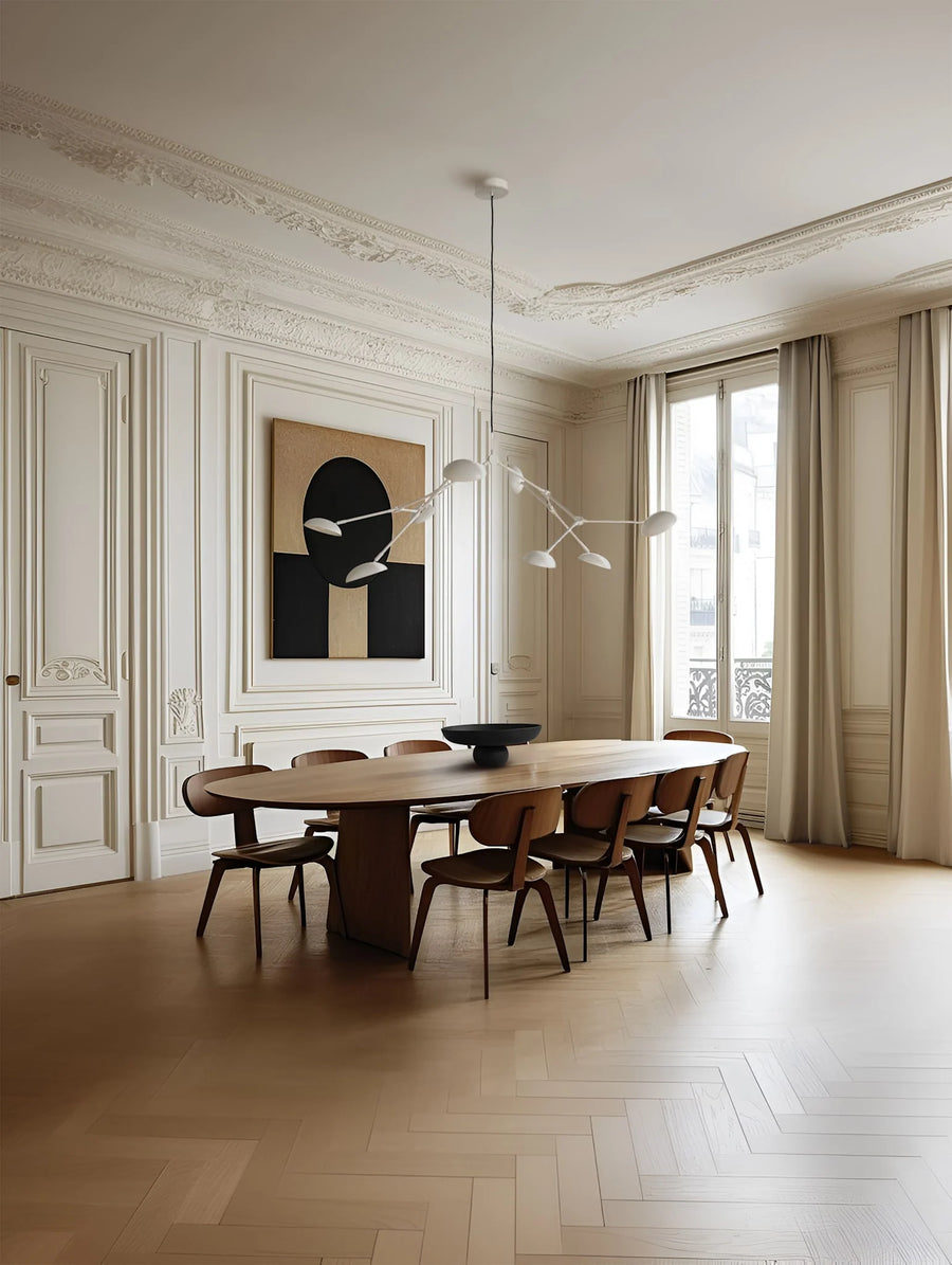 A Scandinavian theme dining room styled with wall art, bowl and a minimal design chandelier. 