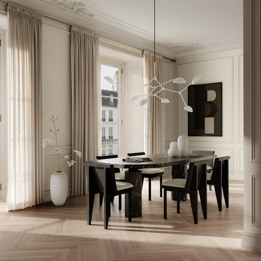 A Scandinavian theme dining room styled with wall art, sculptural vases , bowl and a minimal design chandelier. 