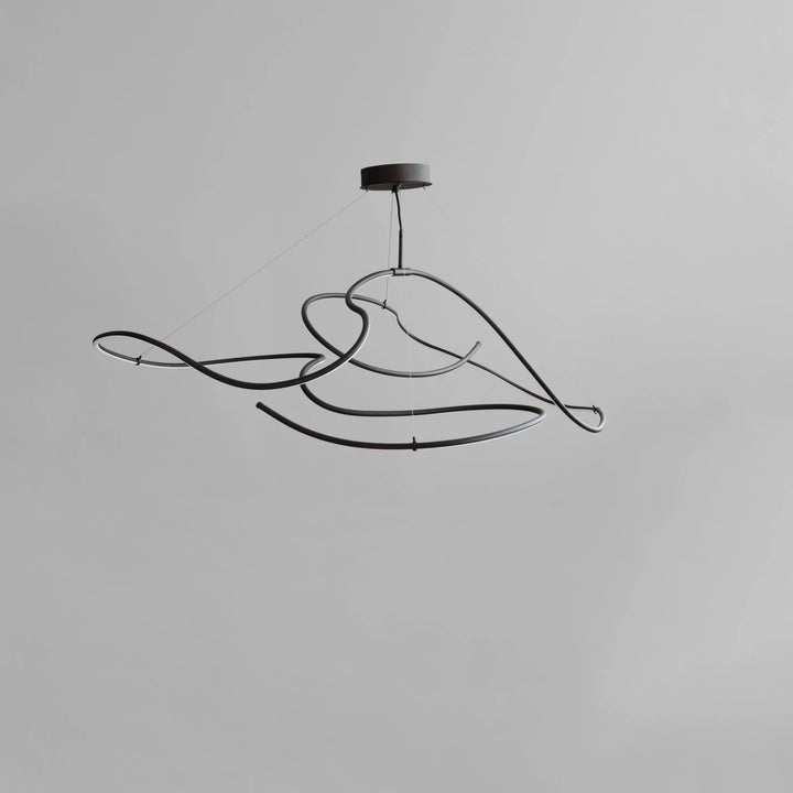 Modern black pendant light fixture on a gray background