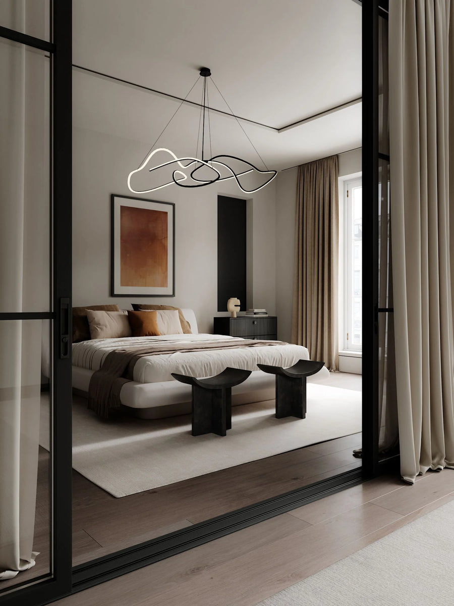 Modern bedroom with a bed, side table, and abstract light fixture.