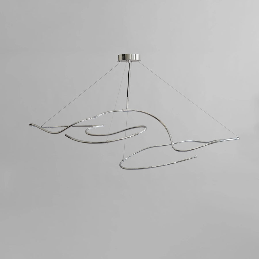 Modern pendant light with wavy design on a gray background