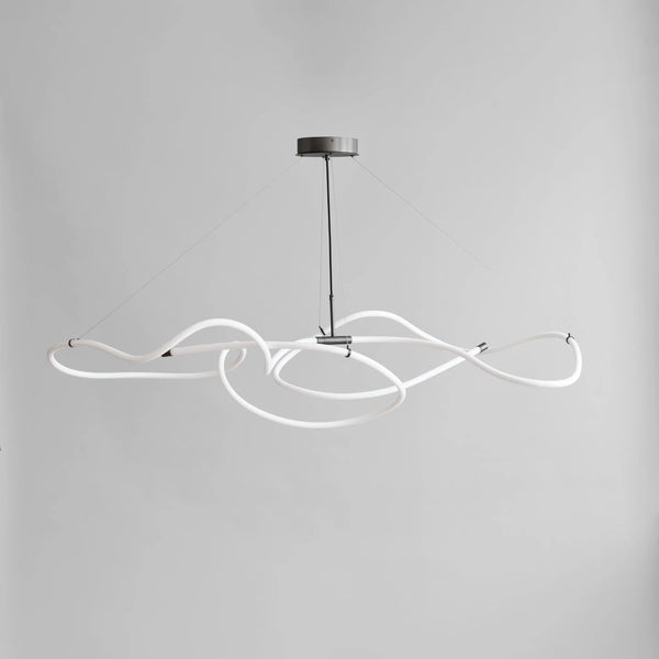 Modern pendant light with white curved design on a gray background from 101 Copenhagen available at Spacio retail stores in Mumbai & Kolkata. 