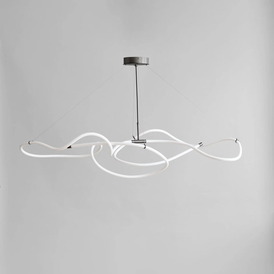 Modern pendant light with white curved design on a gray background from 101 Copenhagen available at Spacio retail stores in Mumbai & Kolkata. 