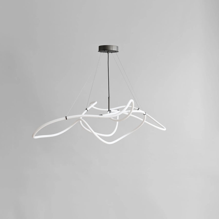 Modern pendant light with white curved design on a gray background