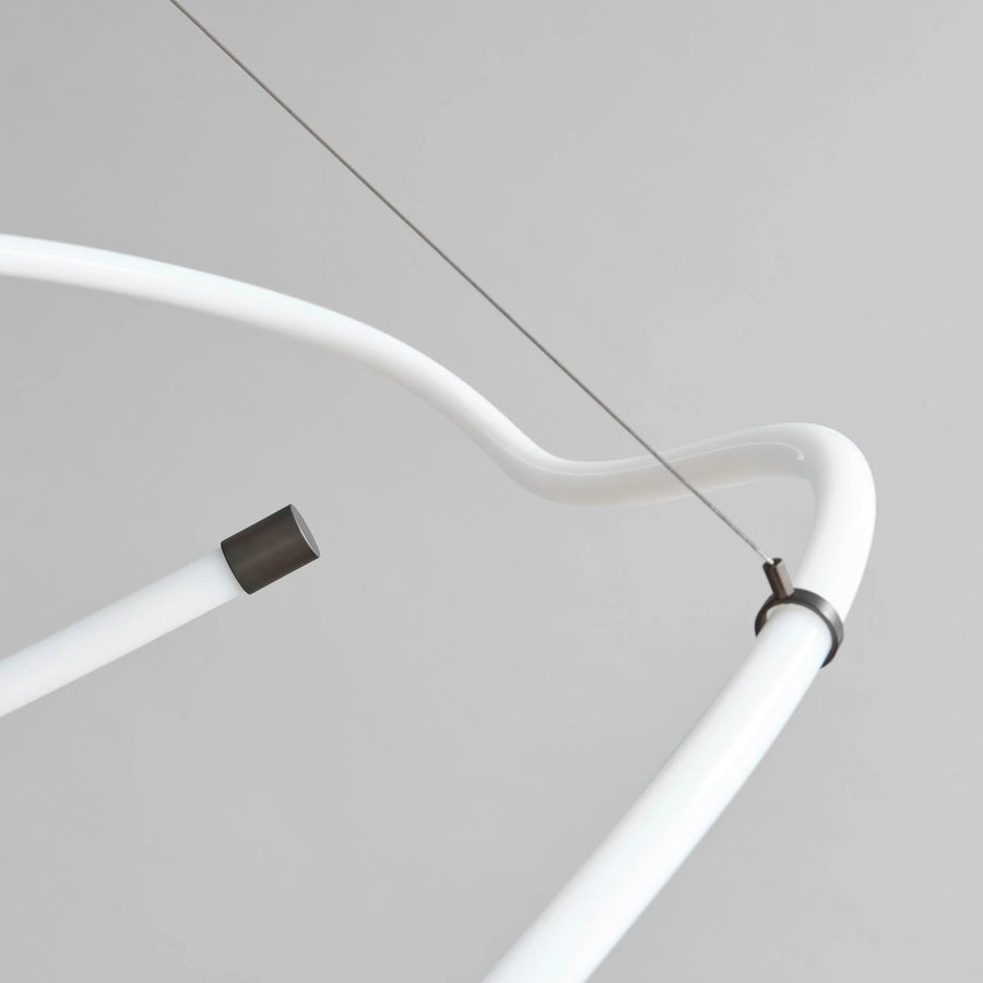 Close-up of a white curved tube with connectors on a gray background