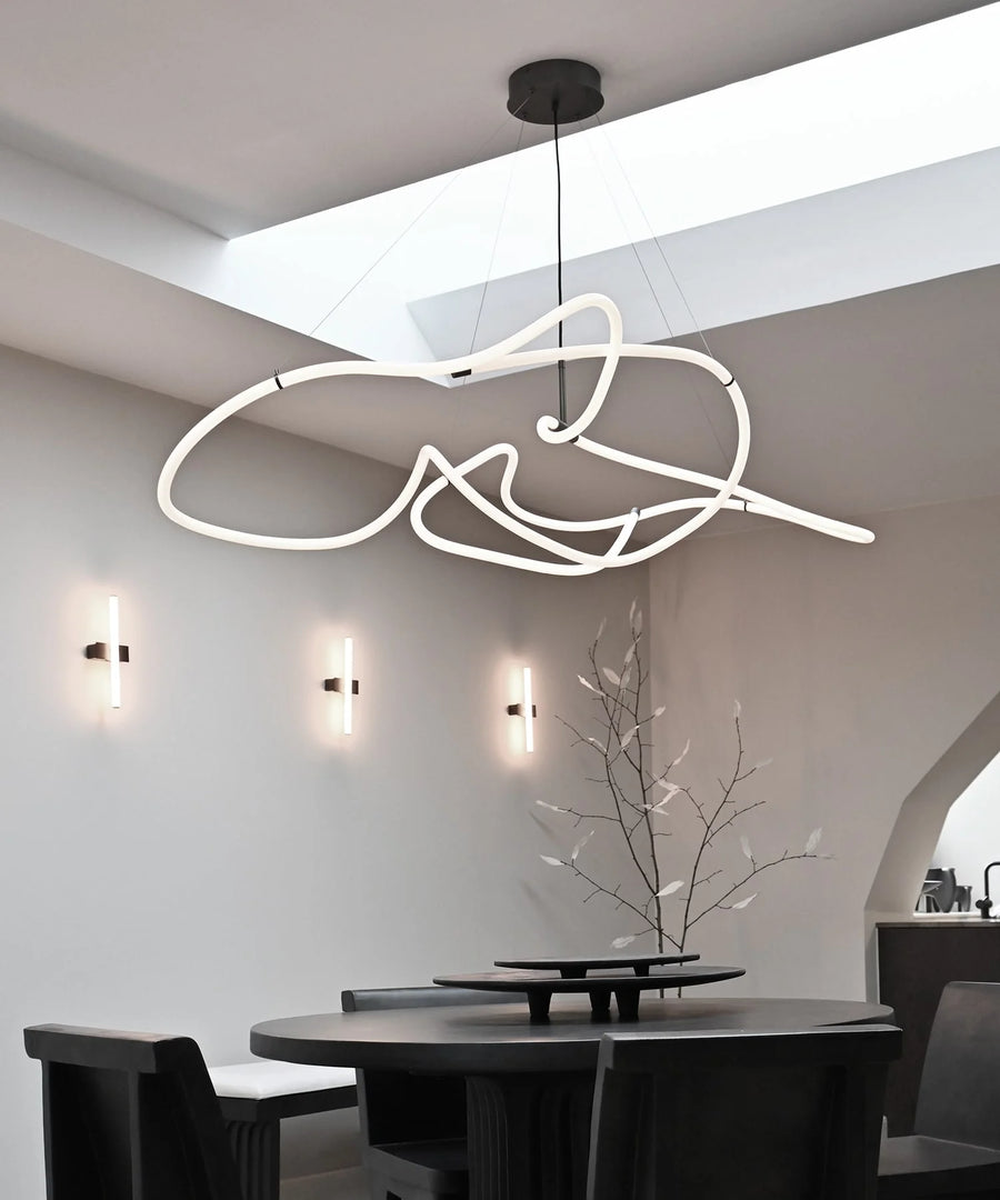 Modern dining room with a unique ceiling light fixture.