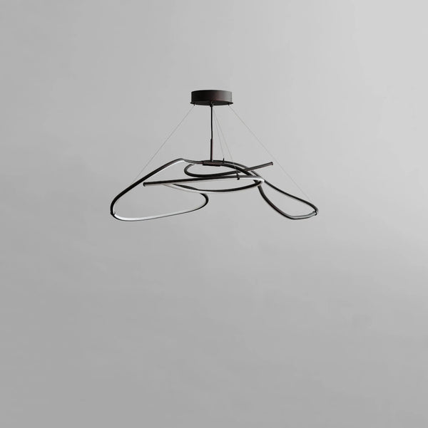 Modern black pendant light on a gray background