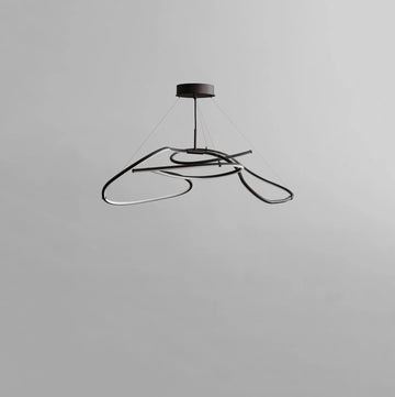 Modern black pendant light on a gray background