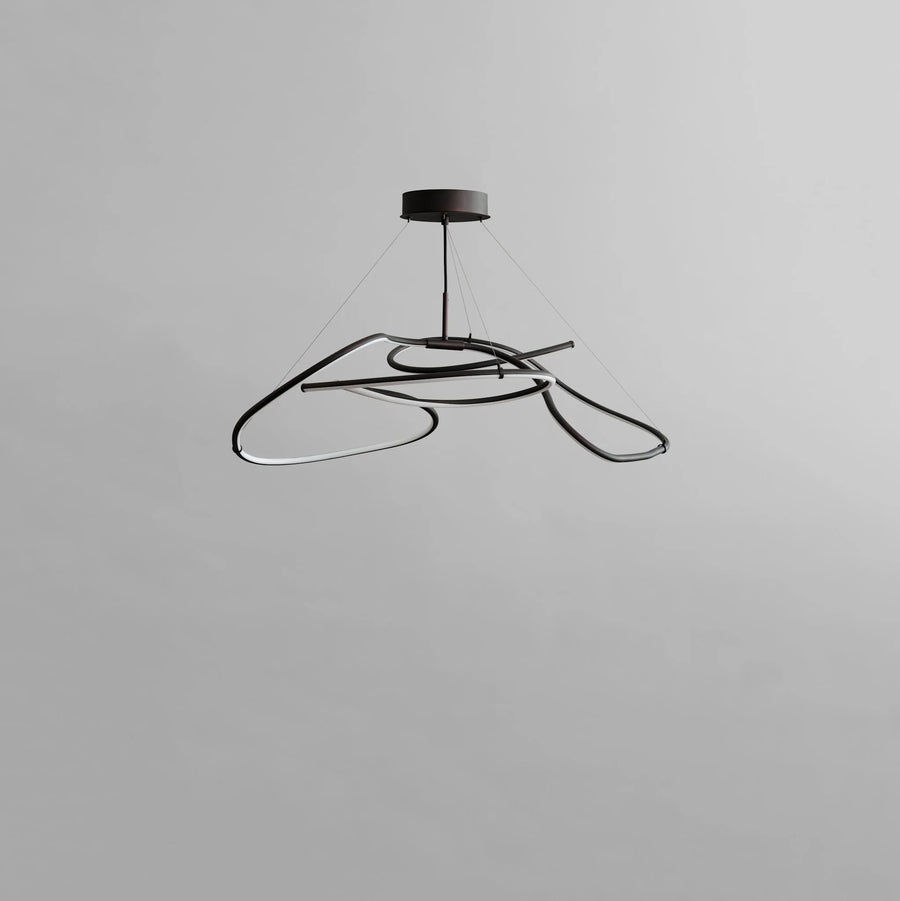 Modern black pendant light on a gray background