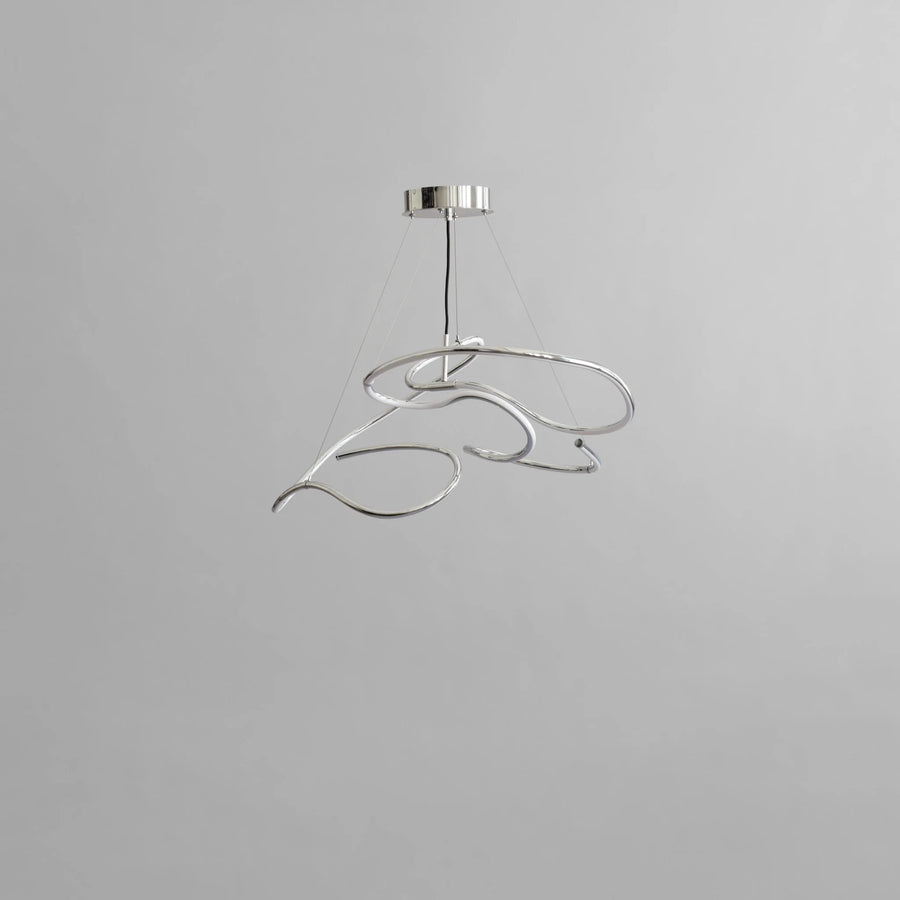 Modern pendant light with a silver finish on a gray background