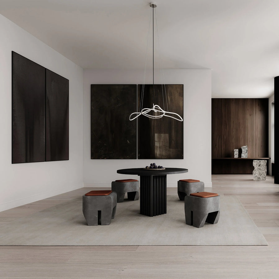 Modern dining room with black table and stools in a minimalistic setting.