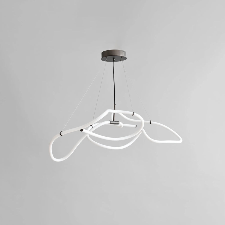 Neon pendant light with white loops on a gray background from 101 Copenhagen available at Spacio retail stores in Mumbai & Kolkata. 