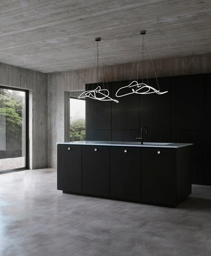 Modern kitchen with black island and concrete walls and floor