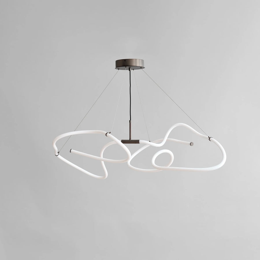 Modern pendant light with white geometric design on a gray background