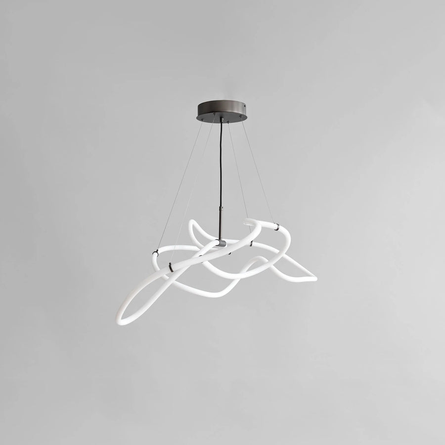 Modern pendant light with white curved design on a gray background