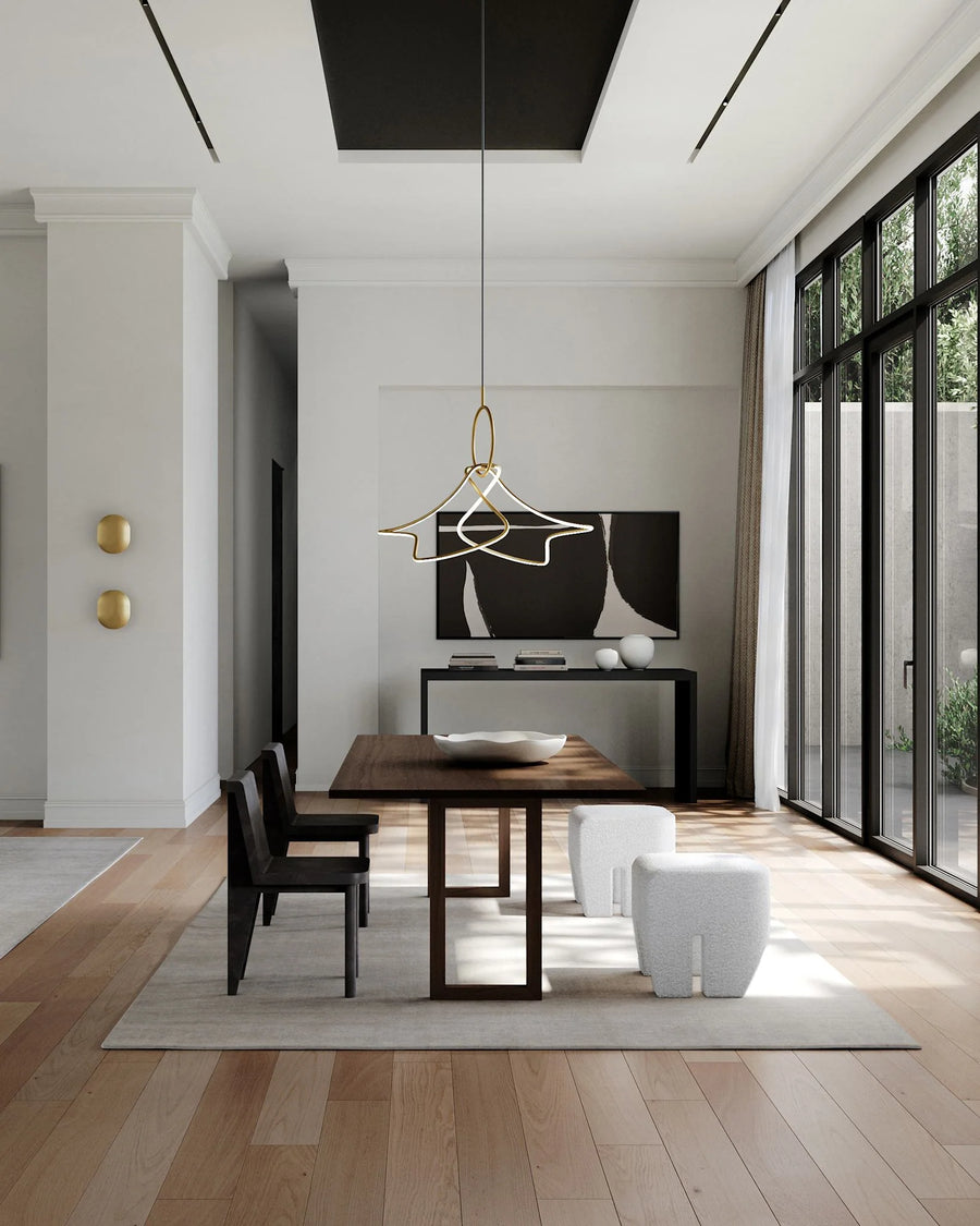 Modern dining room with wooden table, chairs, and a television in a well-lit room.