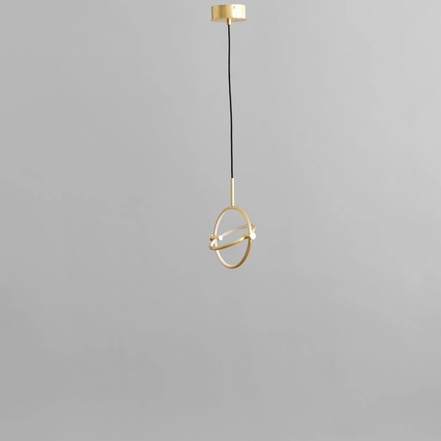 Brass pendant light on a gray background