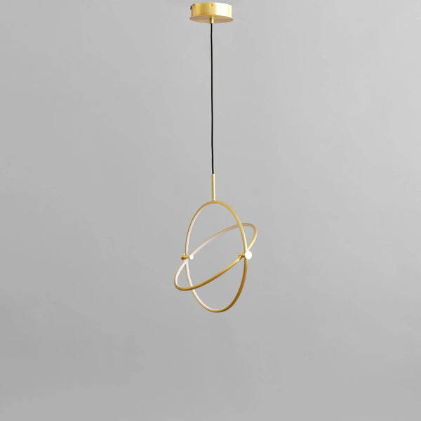 Brass pendant light fixture on a gray background