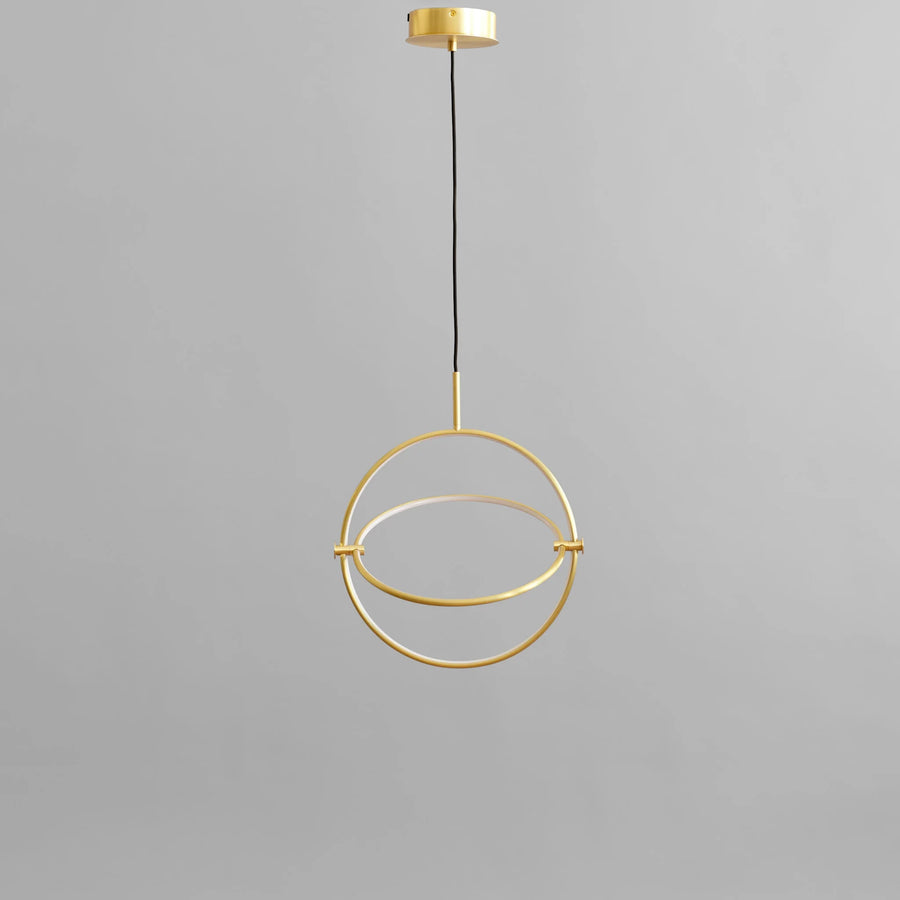 Brass pendant light fixture on a gray background