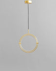 Brass pendant light fixture on a gray background
