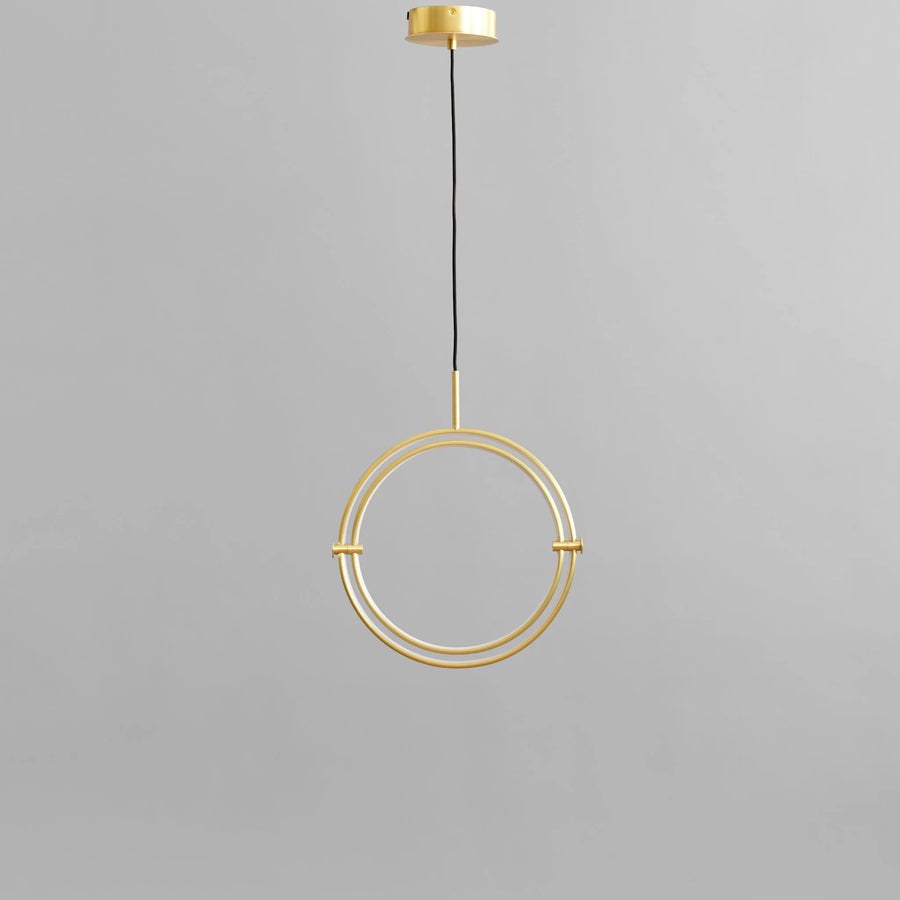 Brass pendant light fixture on a gray background
