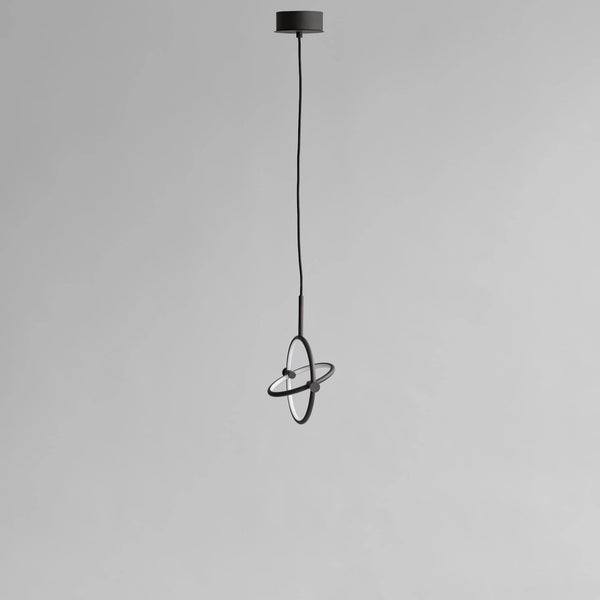 Modern pendant light with black finish on a gray background