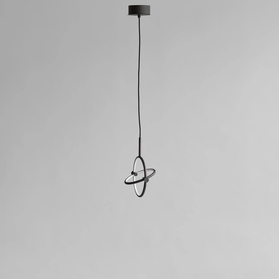 Modern pendant light with black finish on a gray background