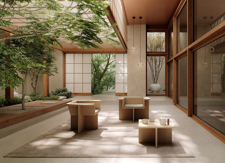 Modern indoor space with wooden furniture and large windows overlooking greenery