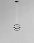 Modern pendant light with circular design on a gray background