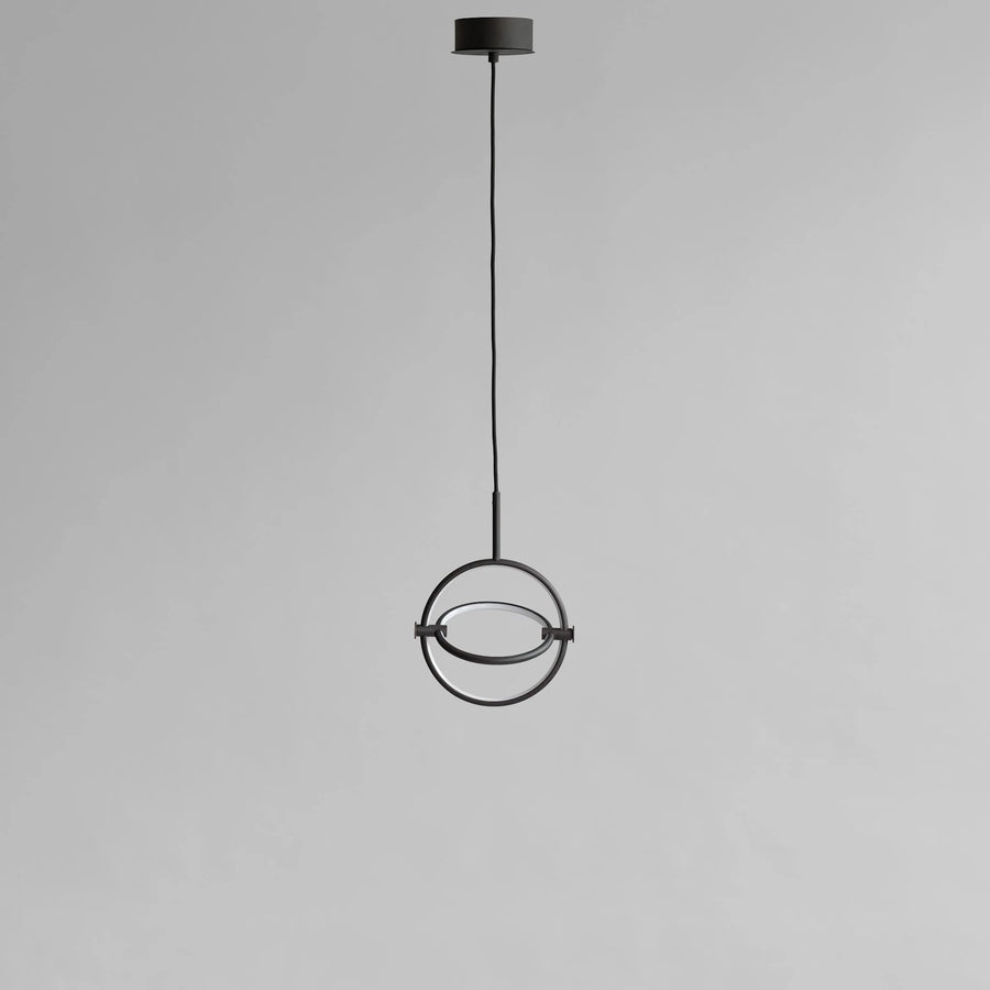 Modern pendant light with circular design on a gray background