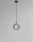 Modern pendant light with circular design on a gray background