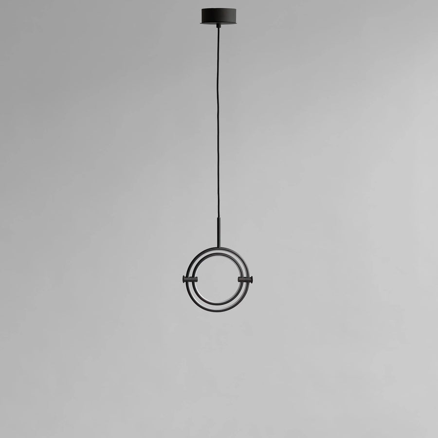 Modern pendant light with circular design on a gray background