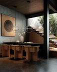 Modern interior design with wooden furniture, abstract art, and a view of trees.