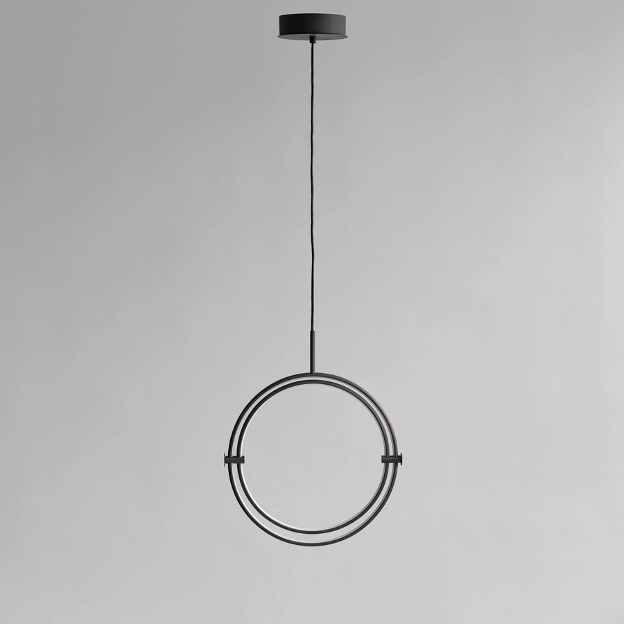 Modern pendant light with circular design on a gray background