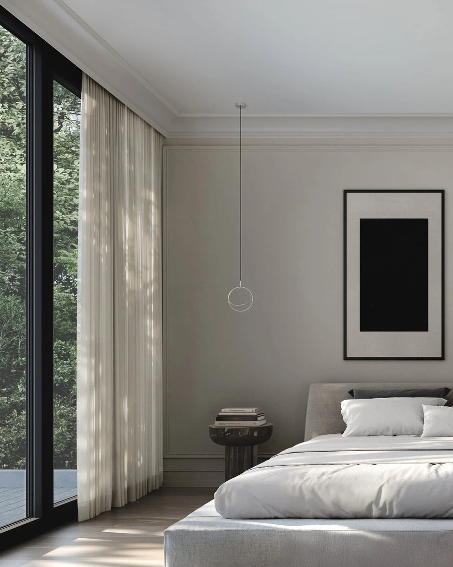 Modern bedroom with a bed, side table, and large window.