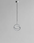 Modern pendant light with circular design on a gray background