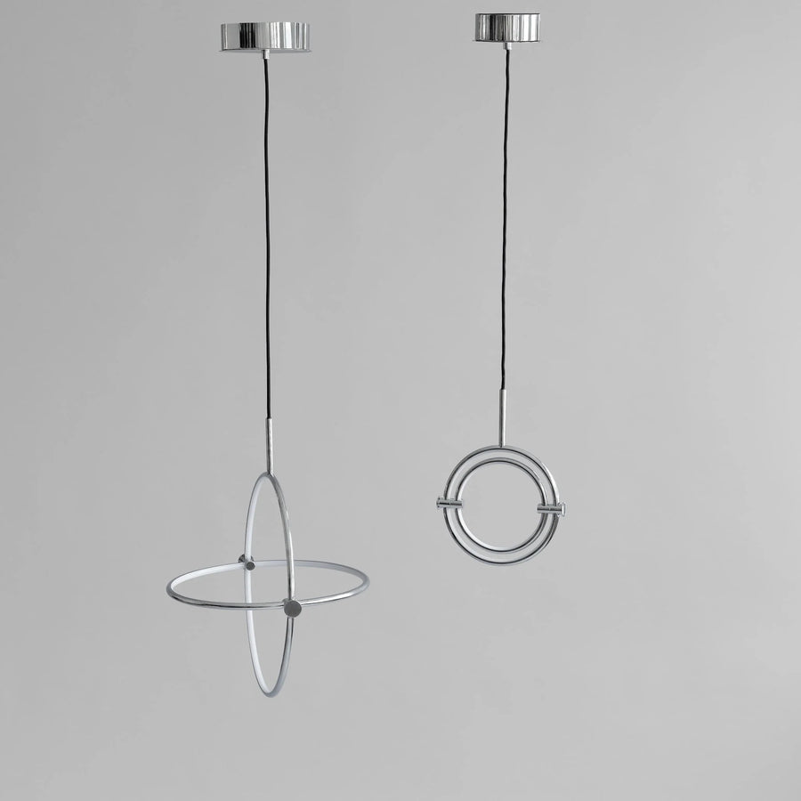 Two modern pendant lights with circular designs on a gray background