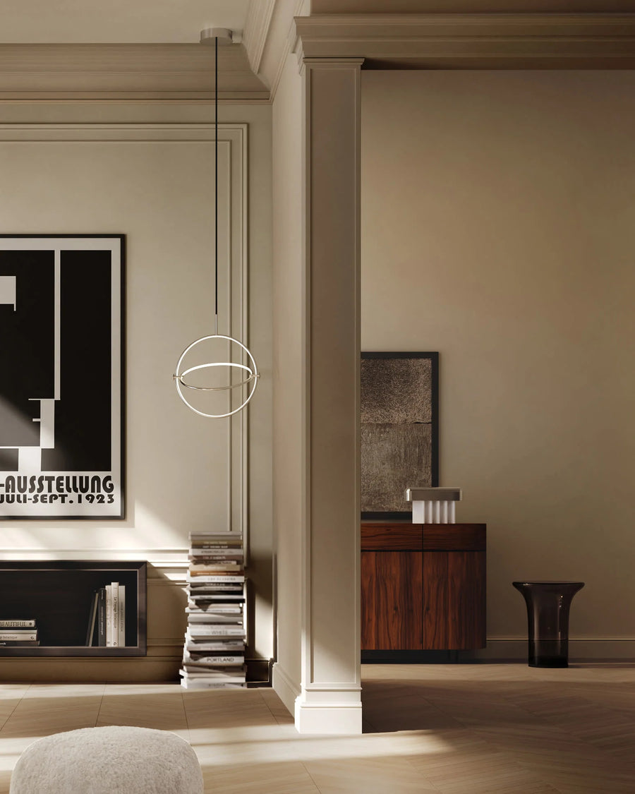 Modern interior design with a lamp, books, and framed pictures on a wall.