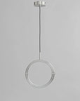 Modern pendant light with circular design on a gray background
