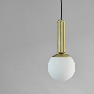 Minimal Scandinavian Pendant light with brass fixture and white bulb on a gray background from 101 Copenhagen available at Spacio retail stores in Mumbai & Kolkata. 