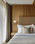 Modern Japandi theme bedroom with wooden headboard and decorative pillows