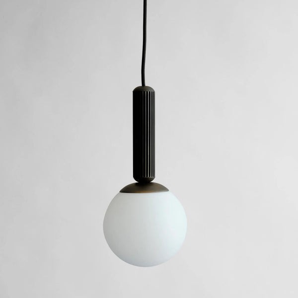 Minimal Scandinavian design white pendant light with black fixture on a plain background