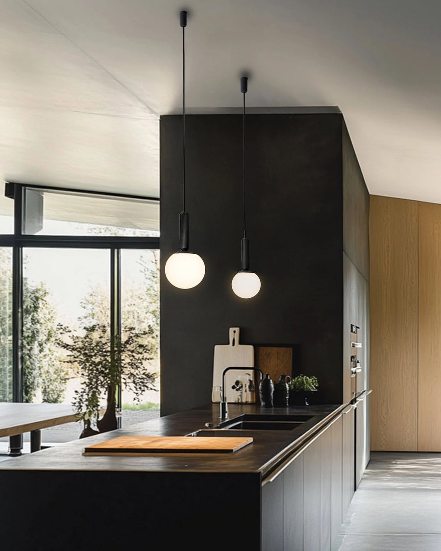Modern Scandinavian theme kitchen with black walls, wooden cabinets, and pendant lights.
